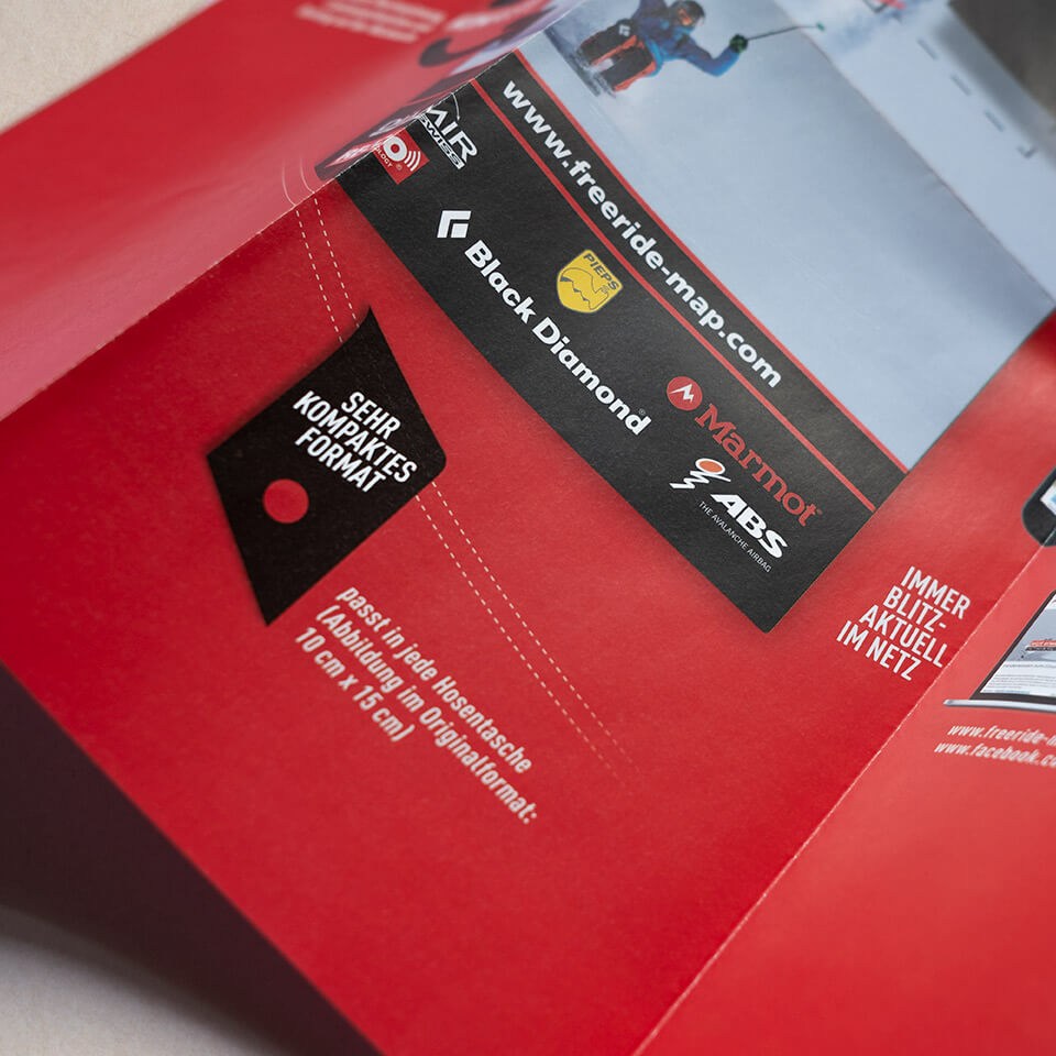 Closup of Mockup of a red Freeride Map Folded Flyer